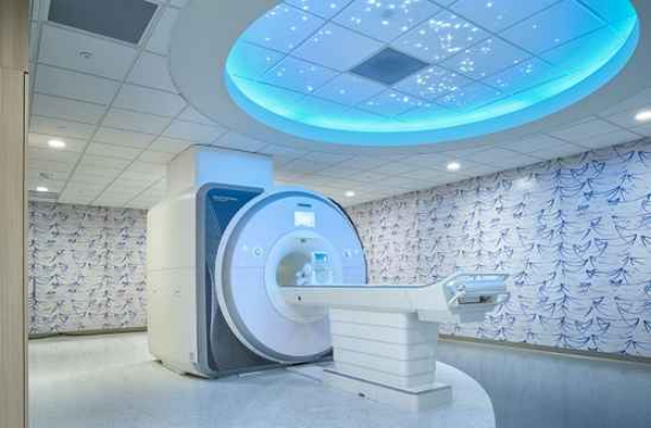 An MRI machine surrounded by seascape imagery