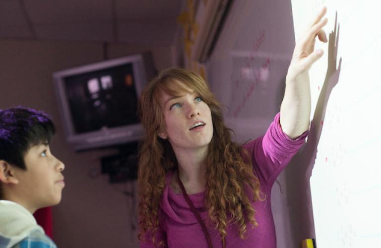 teacher and student looking at screen