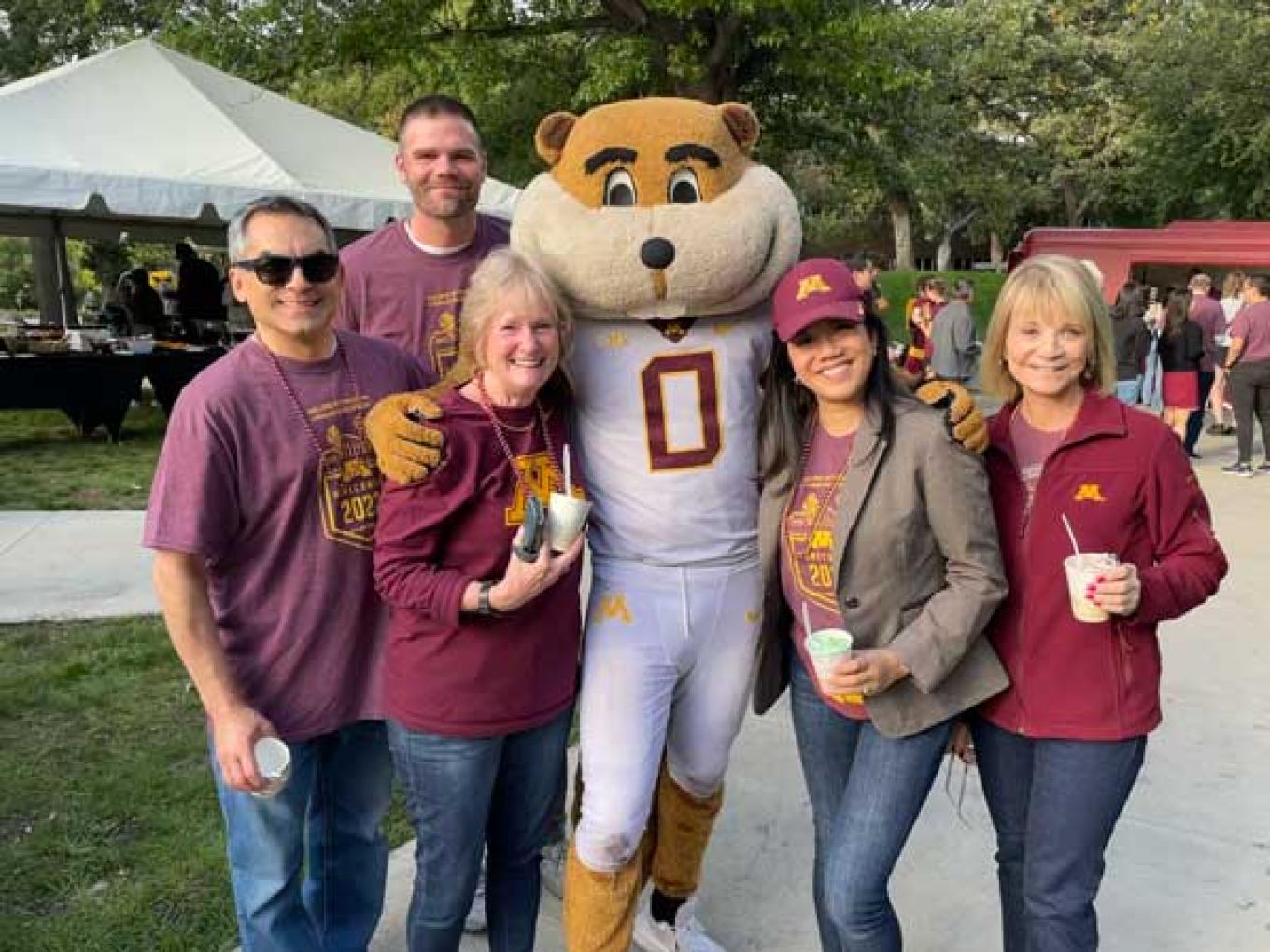 goldy gopher with alumni outside