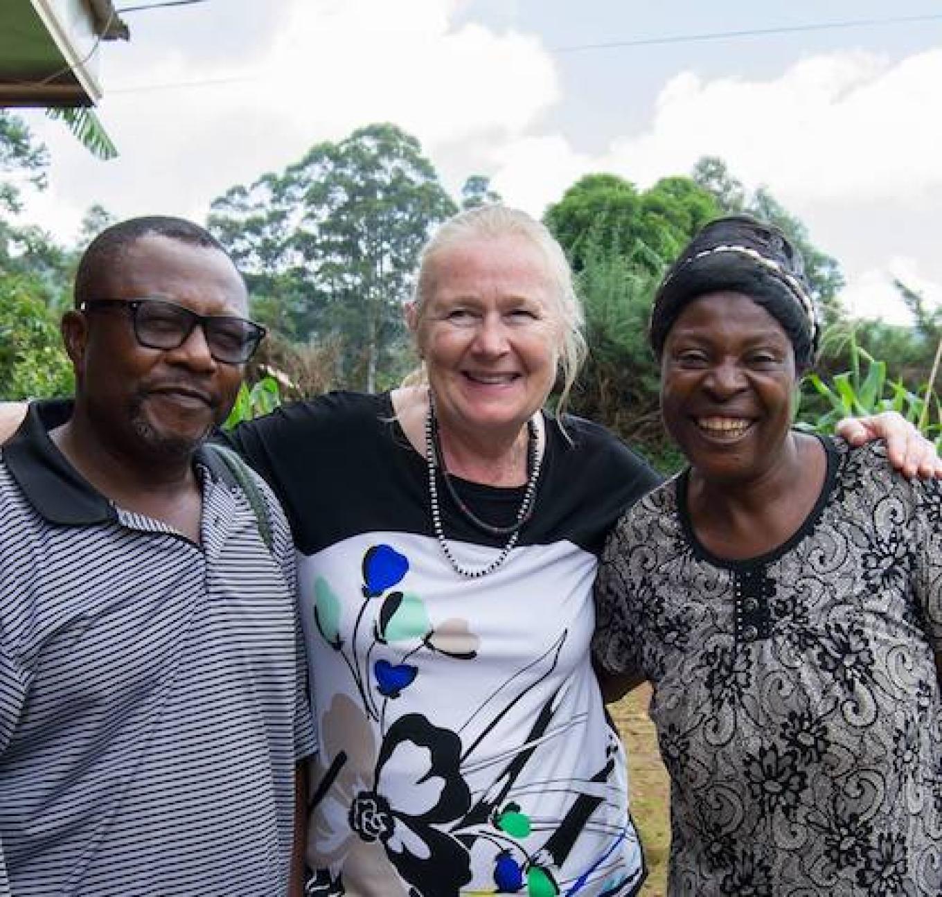 Mary Tjovold stands with Chi, a potato farmer, and Queen Mary, a dairy farmer, in Cameroon 2024